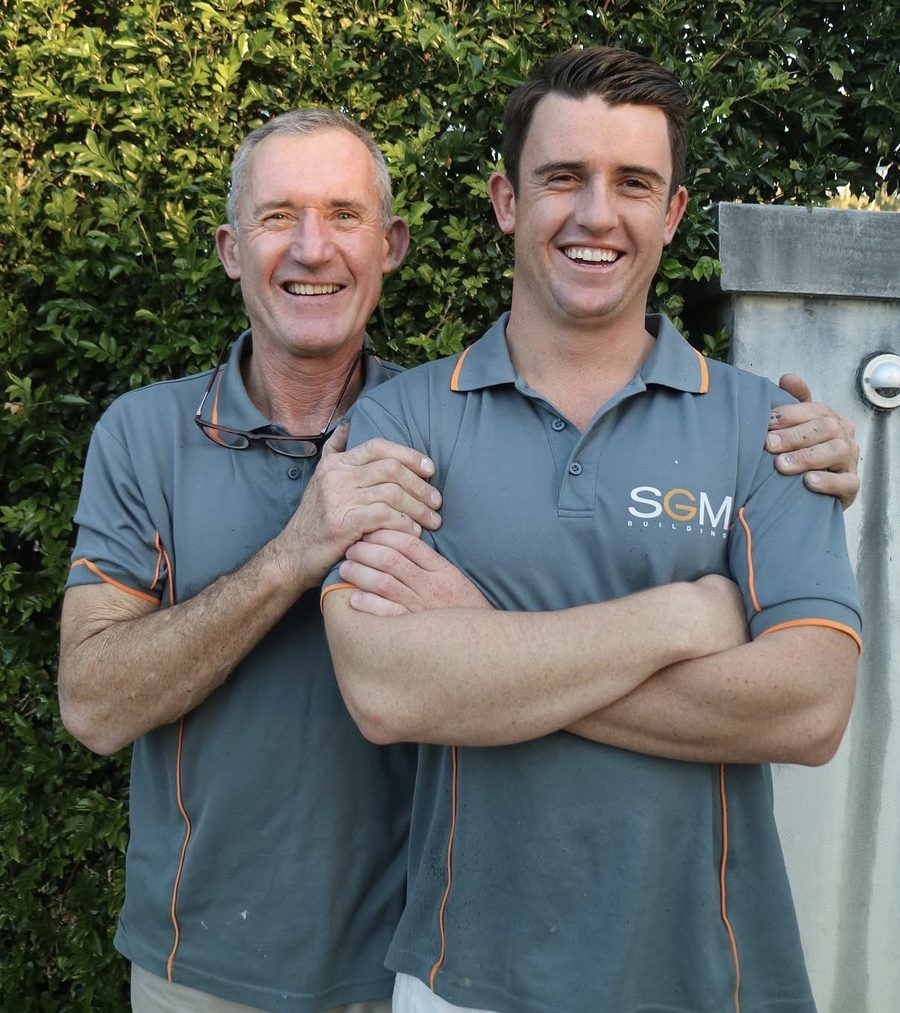 Sean Mahoney (right) with his father Greg (left) in SGM Building uniforms